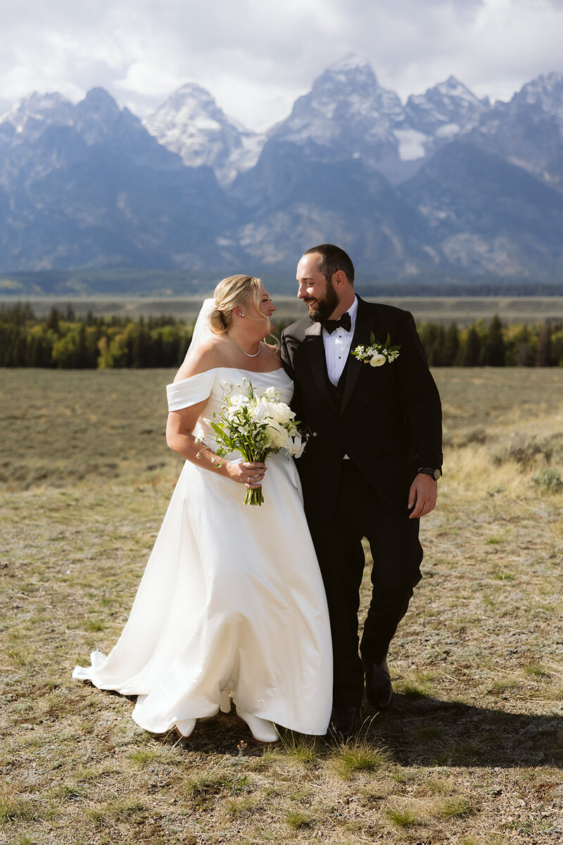 A couple looking into each others eyes laughing in the Sawtooth mountains in Stanley, Idaho