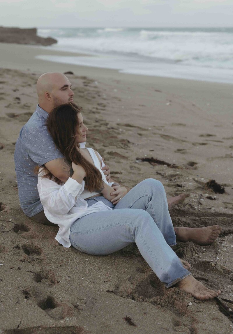 Couple embracing sitting on a beach