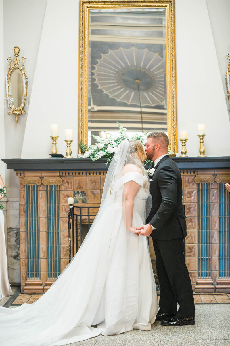 first kiss at elegant wedding venue estate