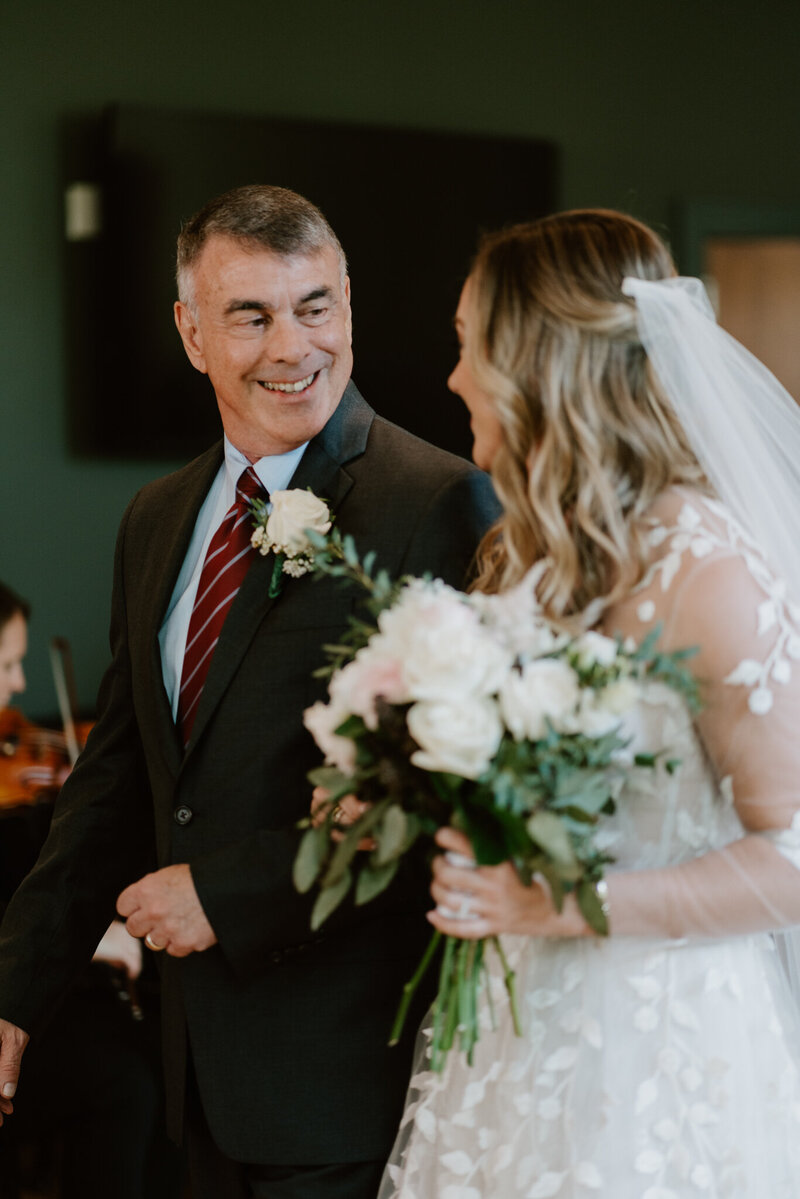 Father of the bride looking at the bride