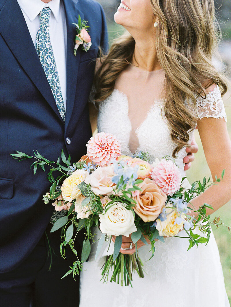 Custom wedding portrait featuring a white, blush, and pink bridal bouquet with dahlias and roses
