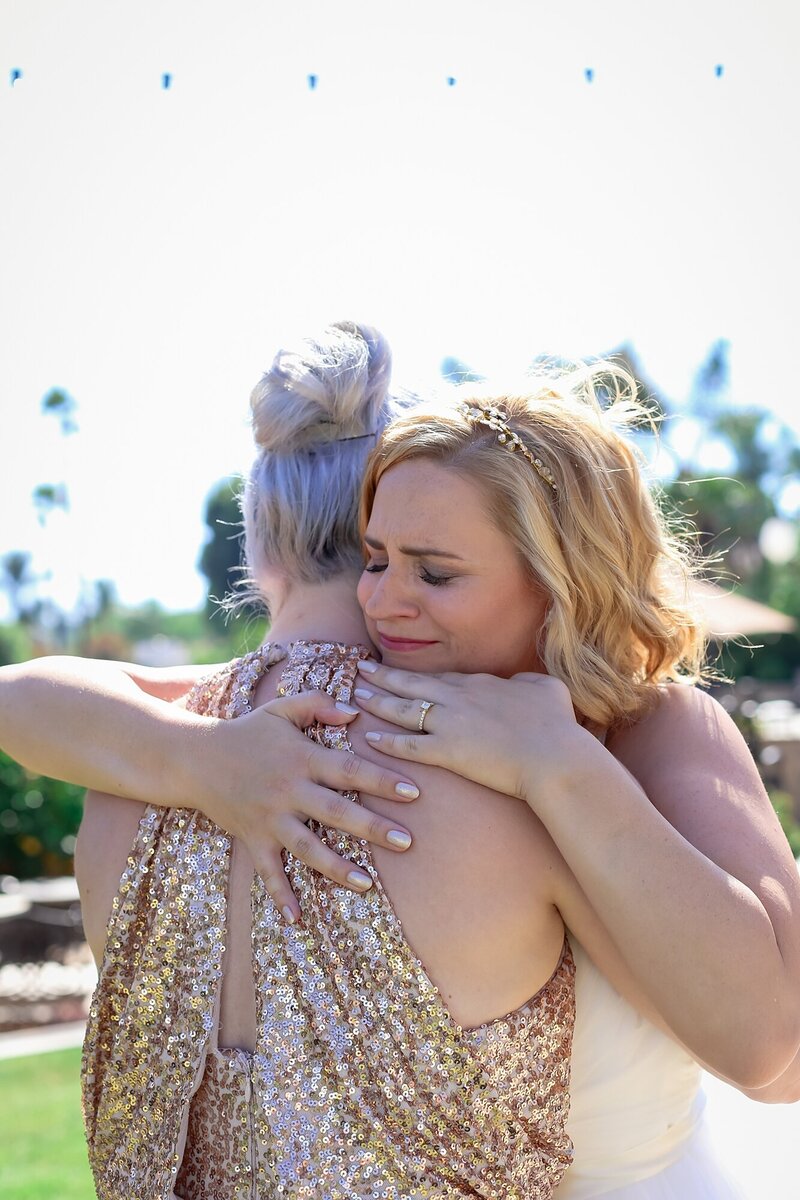 crying bride hugs family member