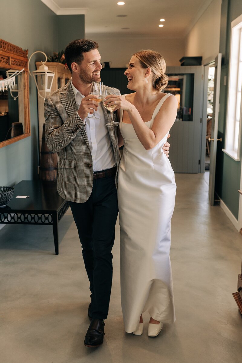 bride and groom cheers champagne in tuscan villa at wither hills blenheim on their wedding day