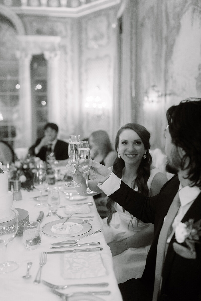 Bride and groom raising glasses