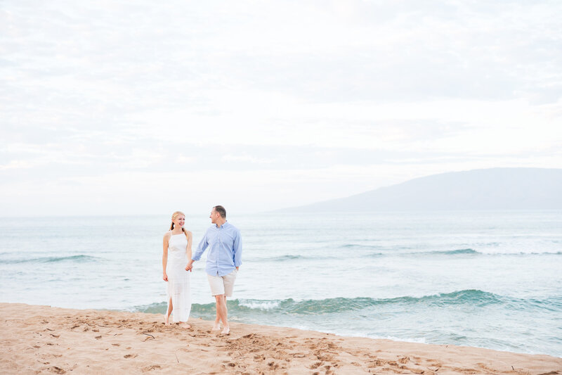 Ka'anapali Beach Elopement Bride and Groom walking down beach hand in hand with the island of Lanai in the background