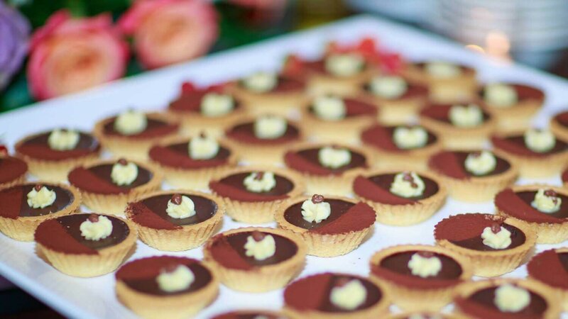 Chocolate tarts erved on a white tray