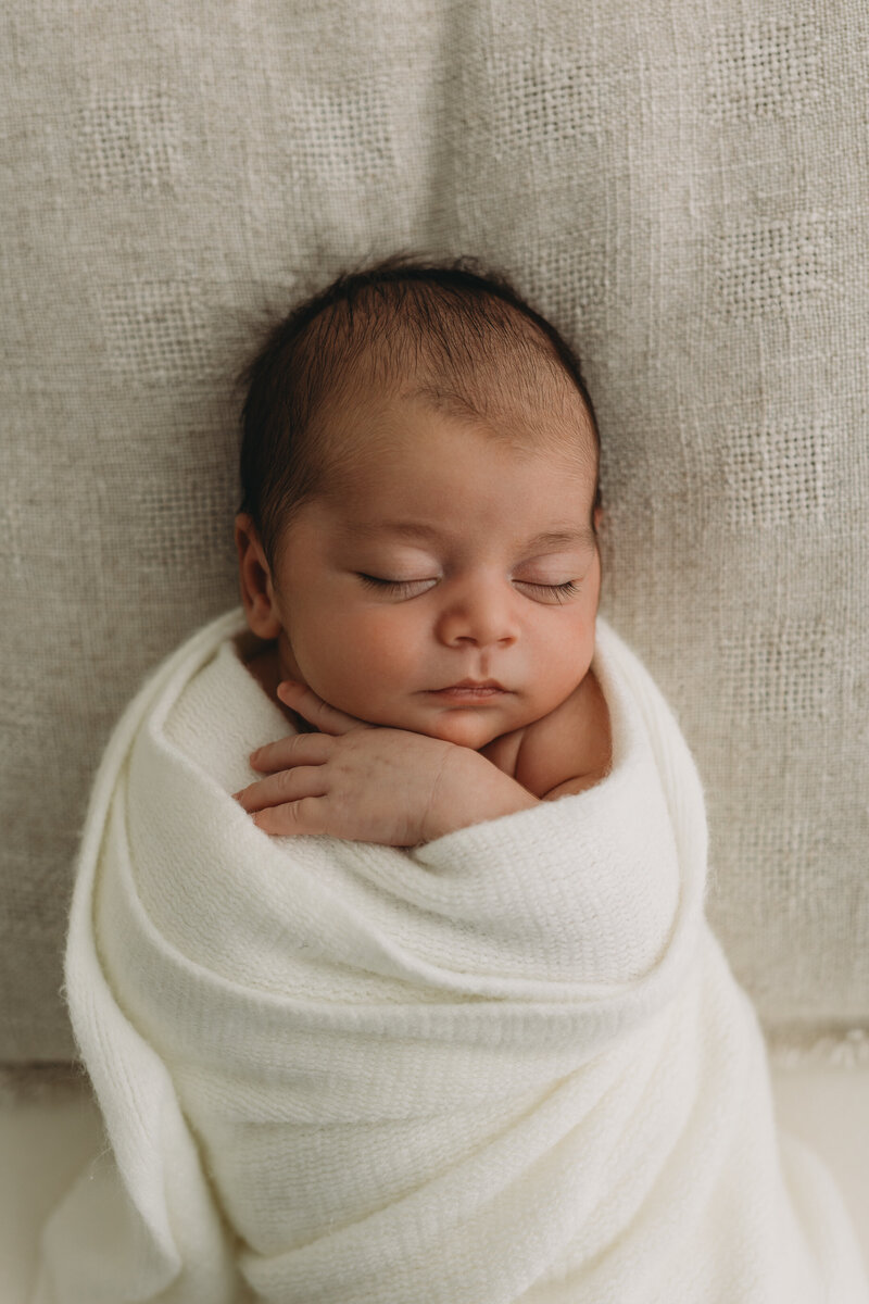 Newborn photo of a baby in studio yawning in Kelowna BC