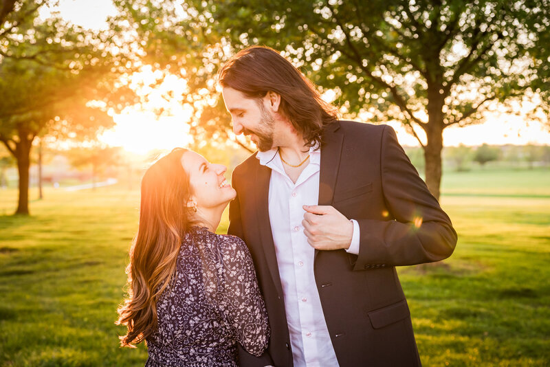 man and woman looking at each other with sunset