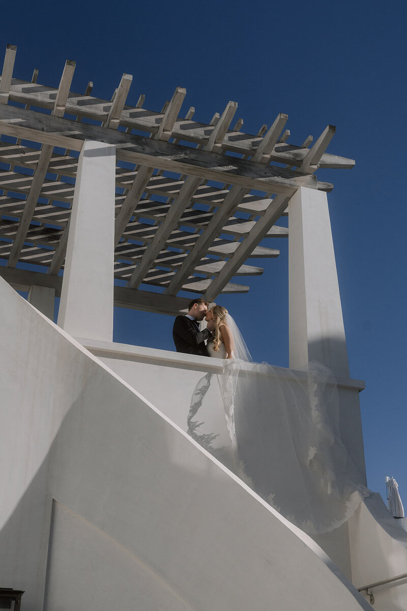 Bride and groom share a moment on their private terrace in Alys Beach