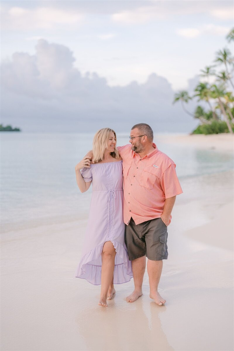 Dana, female founder of DWD travel, honeymoon, destination wedding & vacation planner walking on the beach