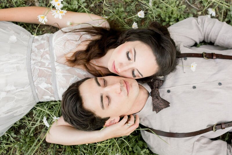 A bride and groom enjoy a walk in mountain meadow of wildflowers on their wedding day. 