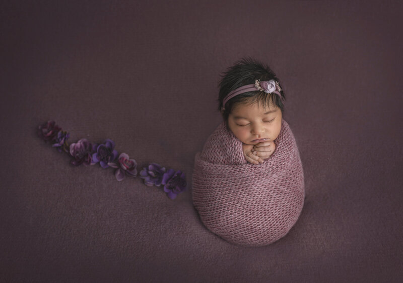  "Newborn baby snugly wrapped in soft, neutral fabric, peacefully sleeping in a timeless and traditional newborn photography pose at Sonia Gourlie Fine Art Photography in Ottawa."