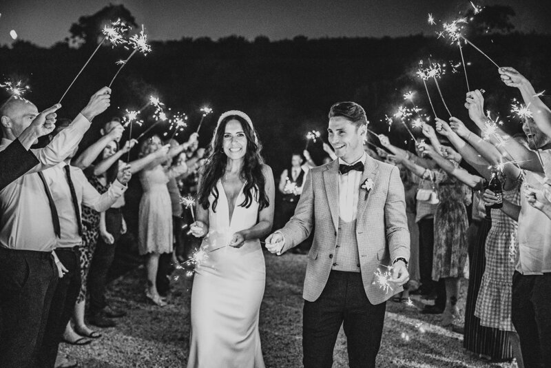 bride and groom walk through a tunnel of sparklers