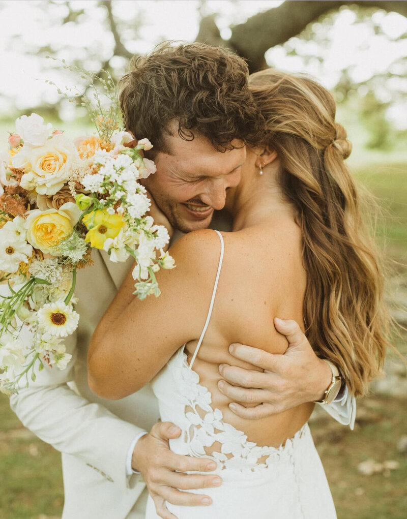 bride and groom hugging