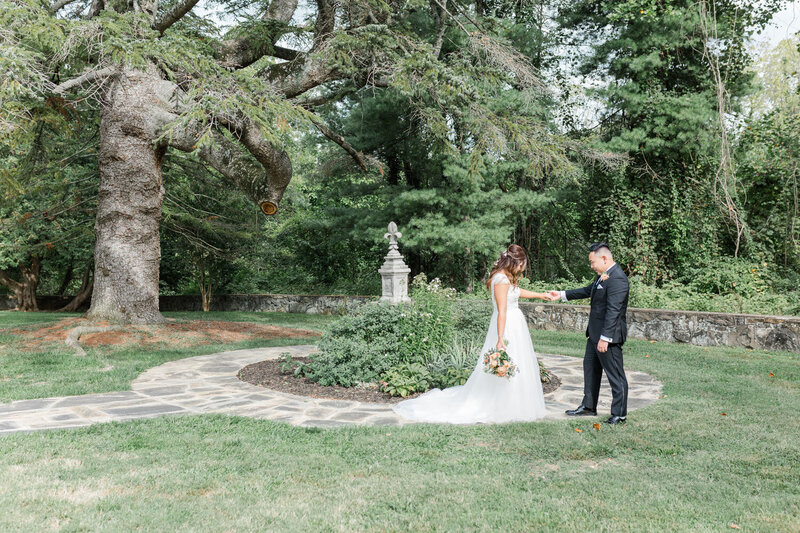 Bride and groom sharing first look in garden setting
