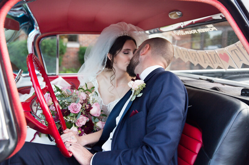 kissing inside vintage car on wedding day in detroit