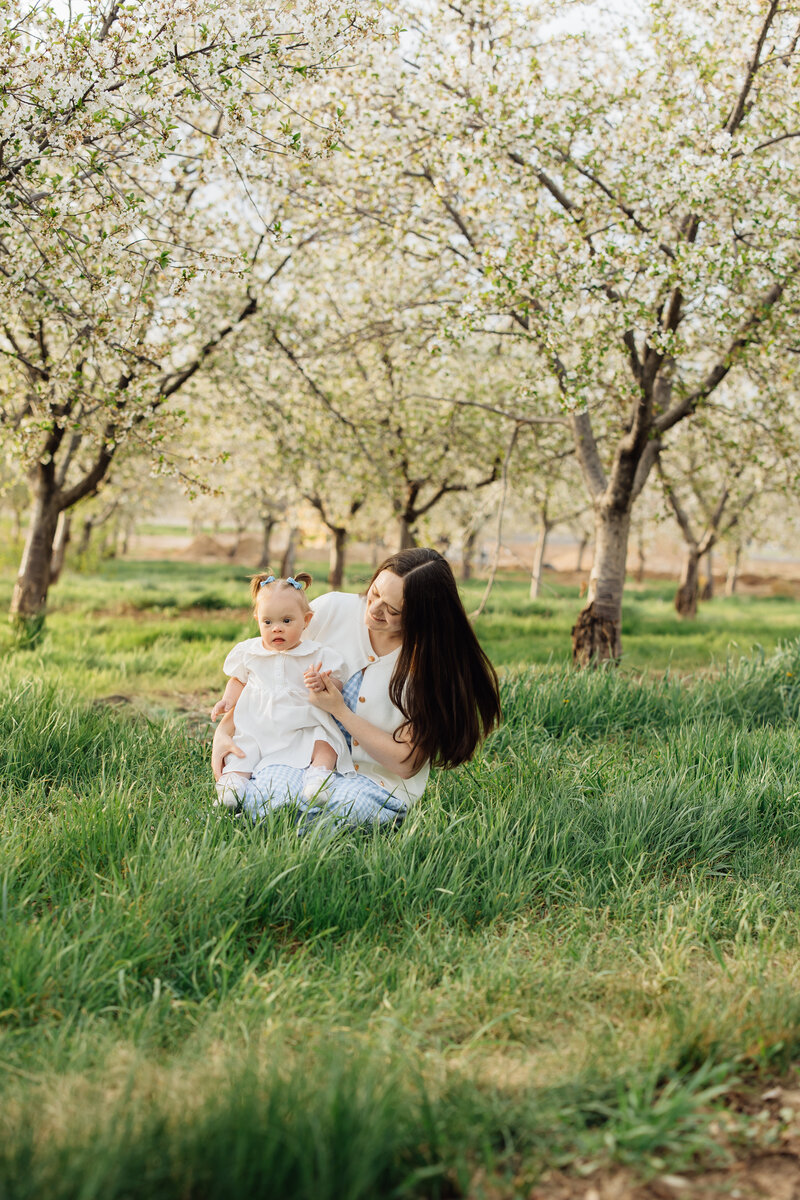mother and baby smile in orchard in santaquin, utah