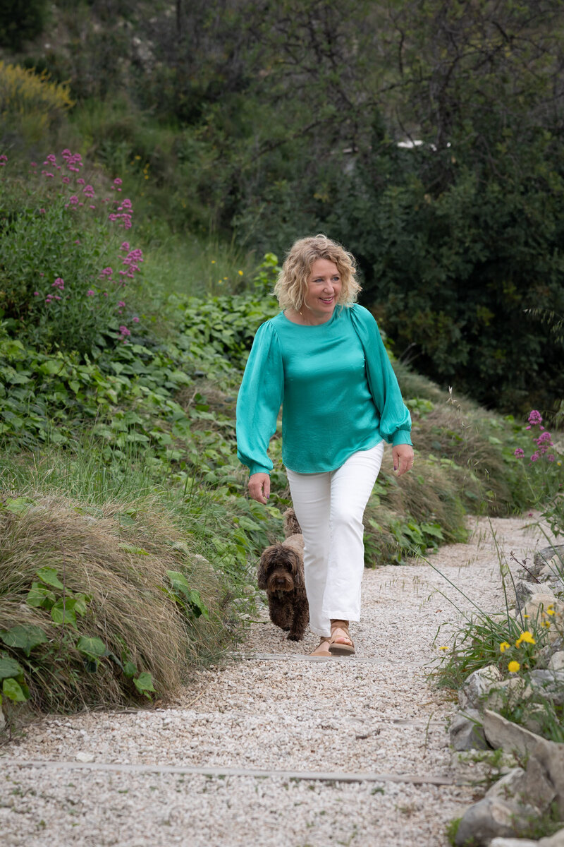 Owner Rosmarijn Fens walks with her dog Brownie in the large natural flower garden.