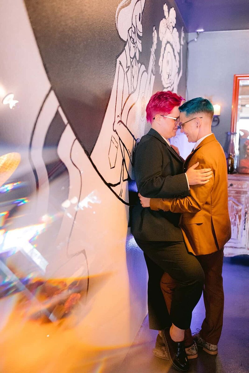 Two Brides snuggling on their wedding day 