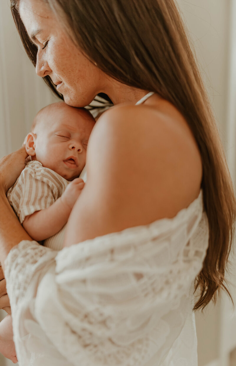 New parents gazing at newborn baby in a warm and tender setting.