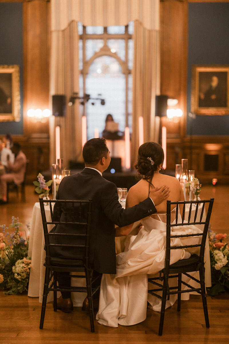 Bride and groom sitting in their wedding reception