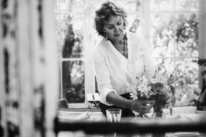 Woman decorating a floral centerpiece on the table