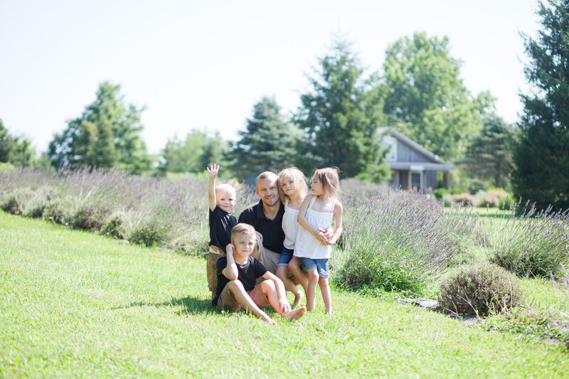 Davide with his kids sitting in a field of lavender flowers