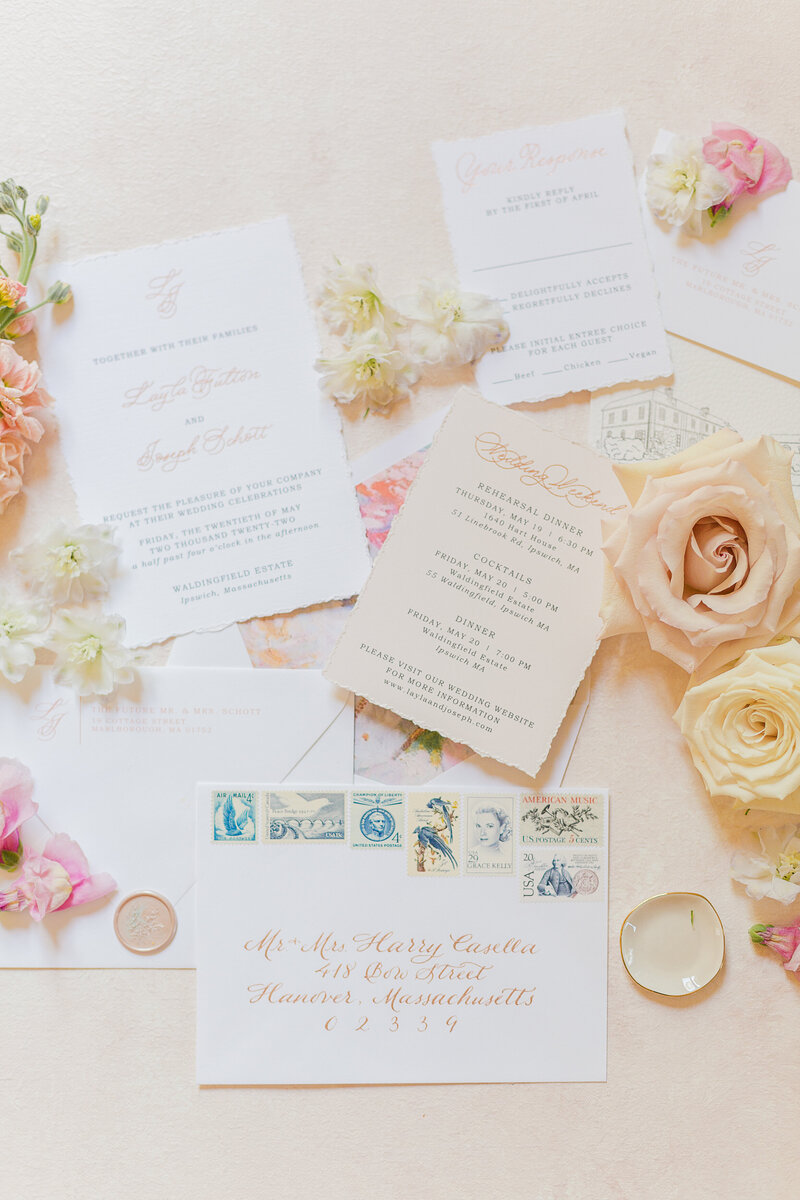 Beautiful styled wedding flat lay featuring rings, invitations, and florals. Captured by New England wedding photographer Lia Rose Weddings.