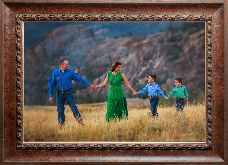 Beautiful family portrait at Vedauwoo  with mom wearing long green dress and boys wearing blue.