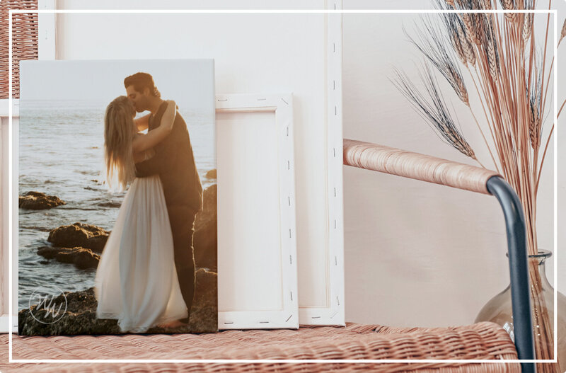 Canvas of a married couple sits on a boho chair.