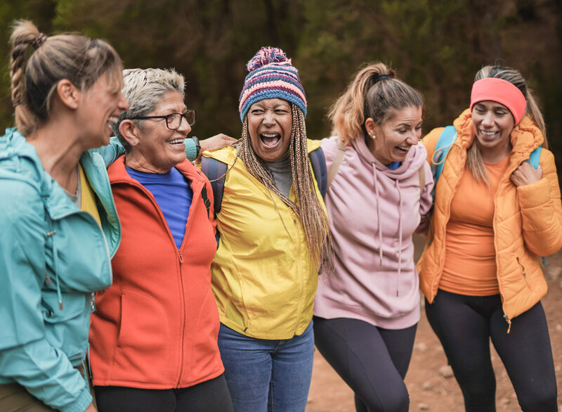 A family laughing together on a hike