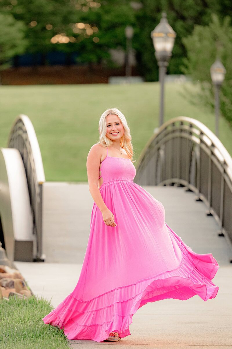 MRSH senior swishes dress and smiles during her grad photos in indian land, sc