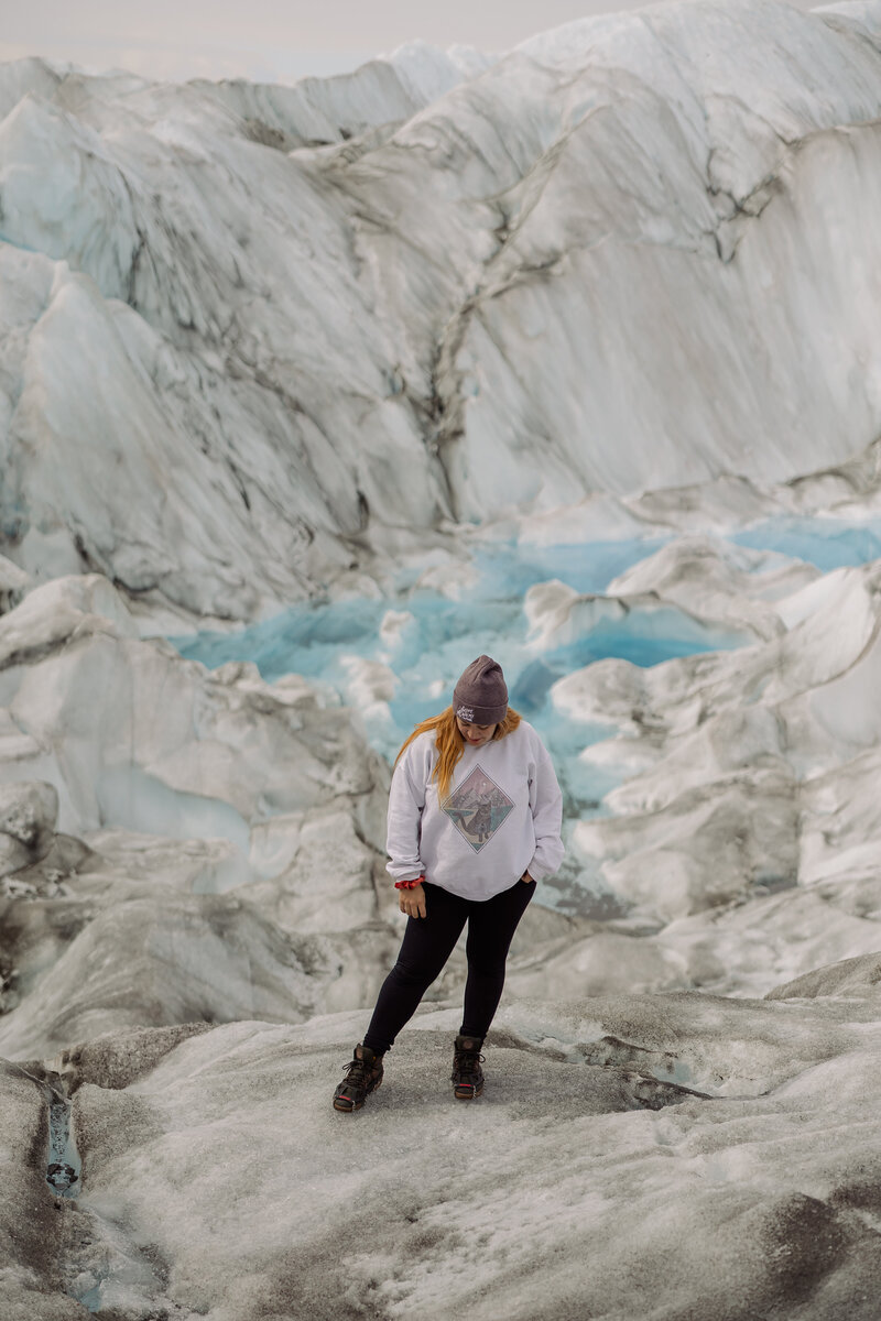 Jamie Tobin Photography posing on a glacier in Alaska during an elopement 