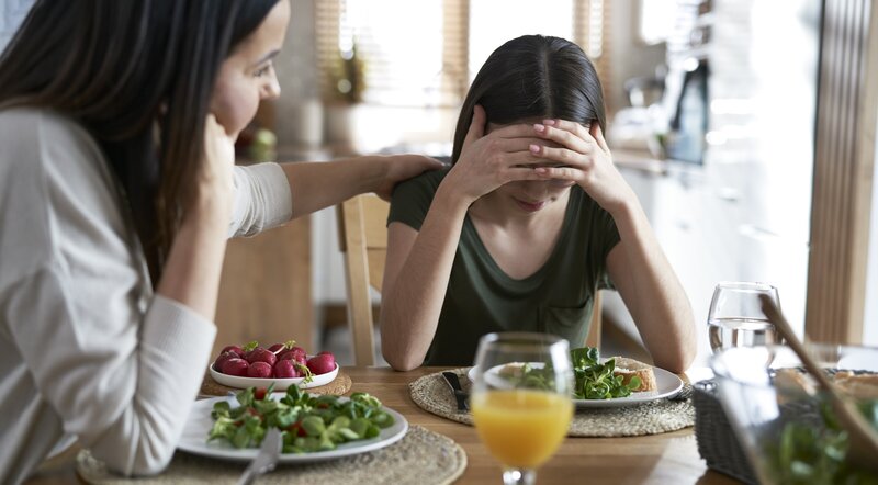 woman consoled by mother food