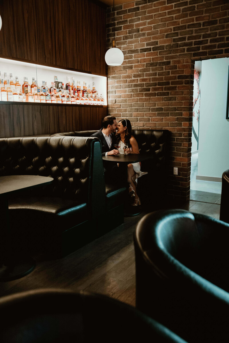 Couple Sitting in Dimly Lit Booth in Bar