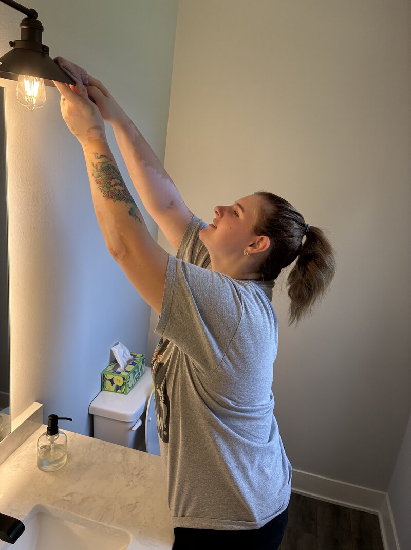Co-founder scrubbing a countertop during a residential deep clean