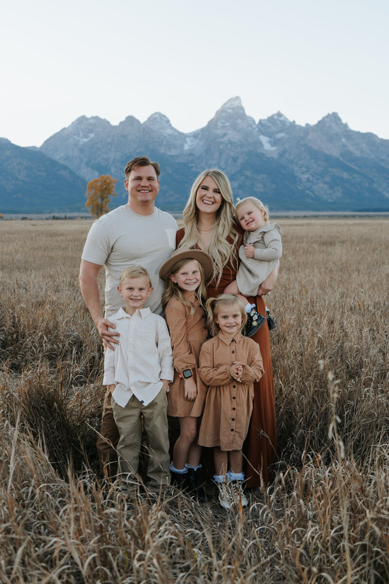 Idaho Falls photographer surrounded by her husband and children in the Grand Teton National Park