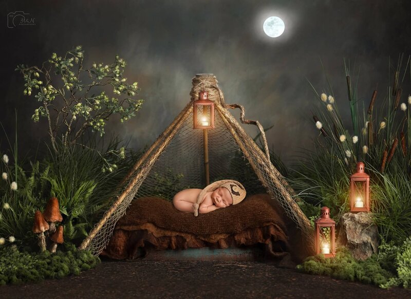 newborn baby sleeping at night in tent in the woods