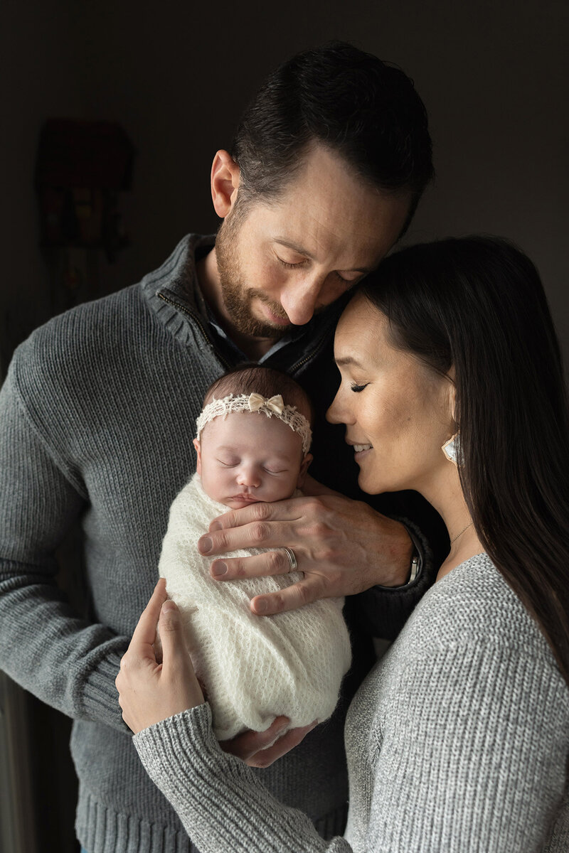 NJ Family Film photographer captures photo of parents holding their new baby close
