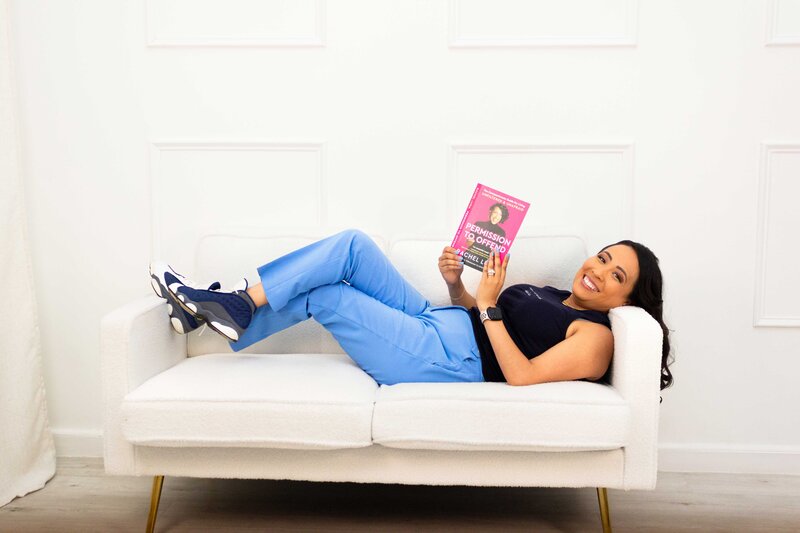 Online career coach reading an important industry book on a comfortable couch to grow in her career