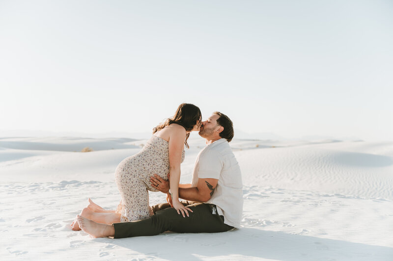 couple sitting down holding each other at White Sands