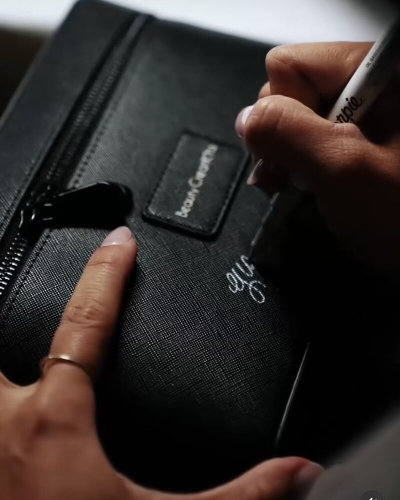 Live event calligraphy on a black leather tote bag