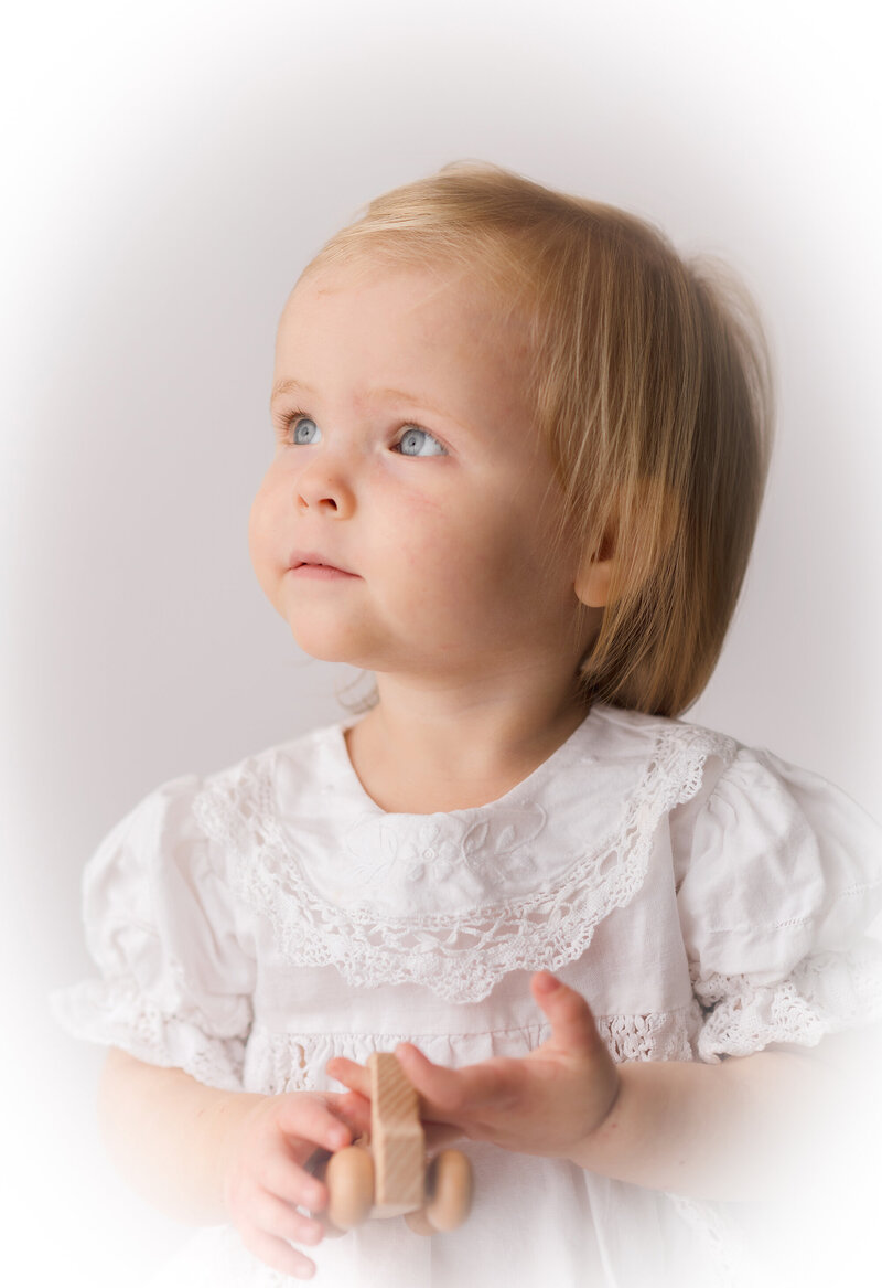 Little girl looks into the light during Studio Milestone Portrait Session in Charleston, SC. 