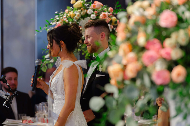 surrounded by pink florals a bride thanks her guests during her Chateau Le Parc reception.  Ottawa wedding photography by JEMMAN Photography