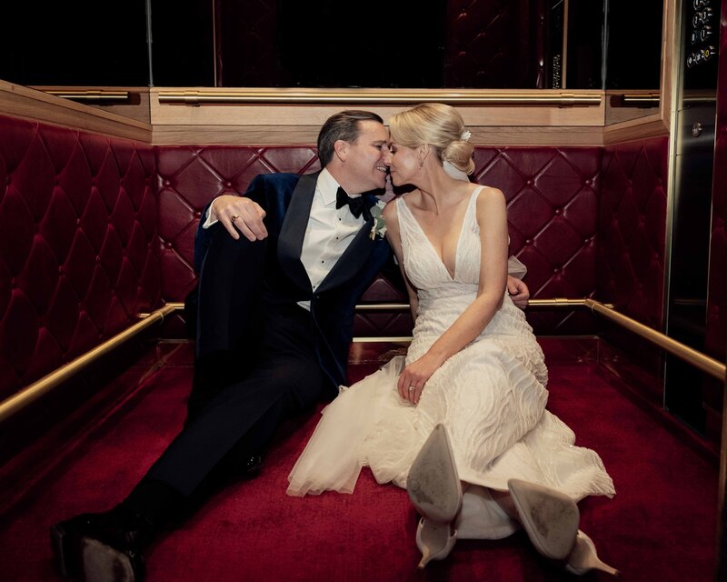 Married Couple sat down in a lift about to kiss