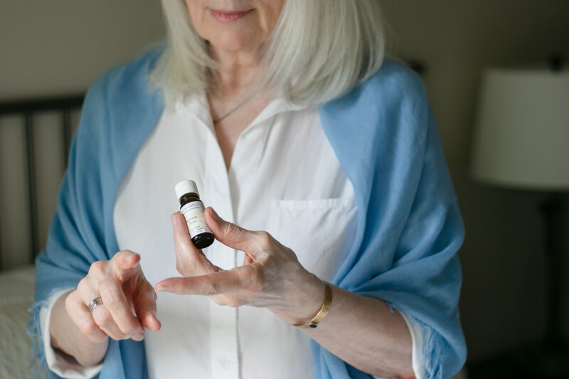 Woman dapping essential oils on her fingers
