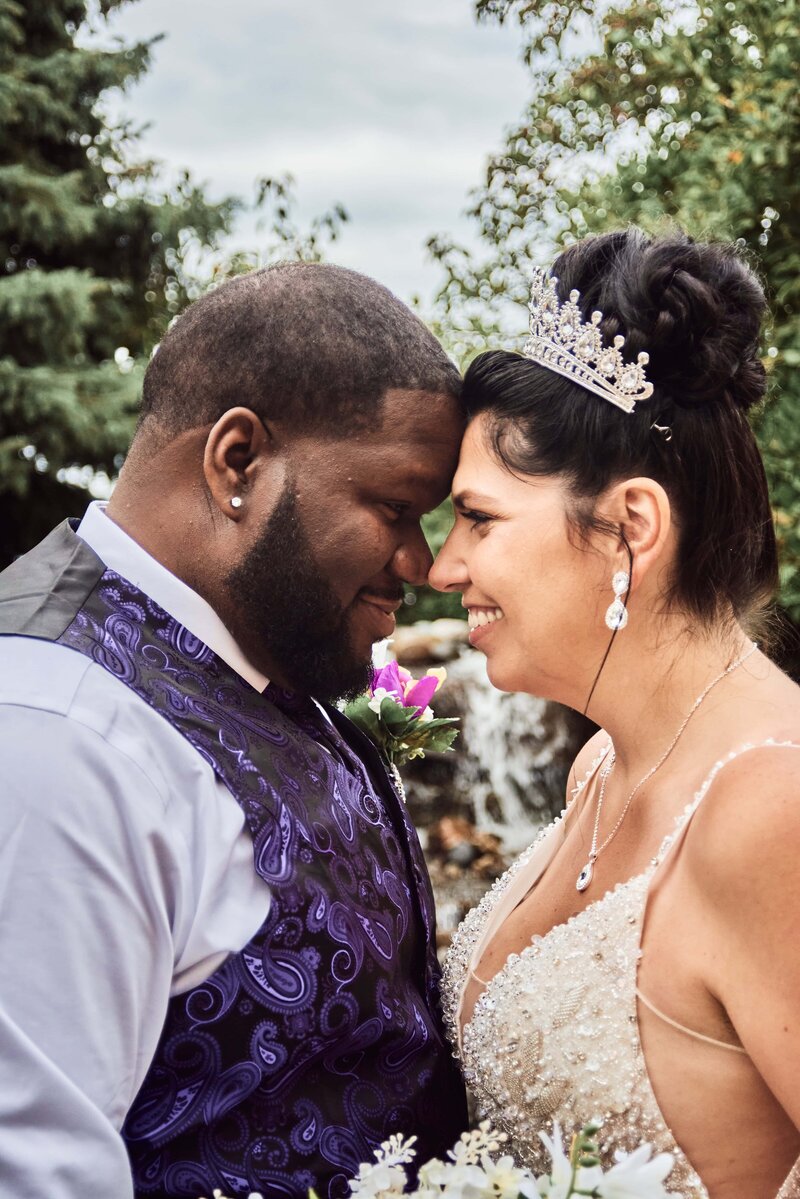 Couple kissing on a bridge at KW Kellogg Mansion in Kalamazoo, Michigan