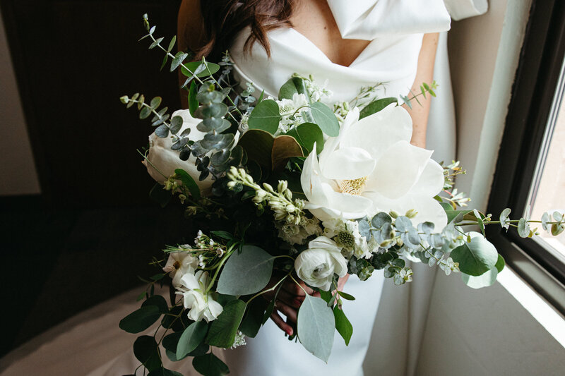 Portrait of modern bride in lace dress at race and religious wedding venue.