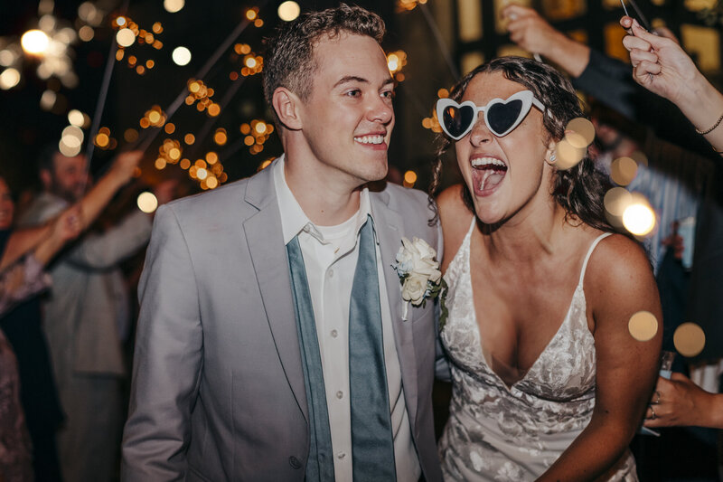 bride and groom pose during reception