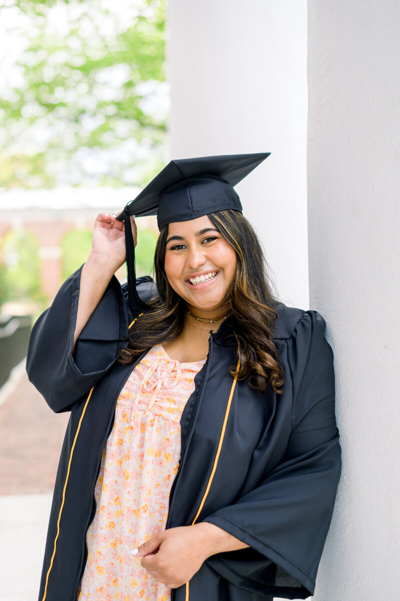 Stands in front of the US Capitol during Baltimore Maryland Grad session